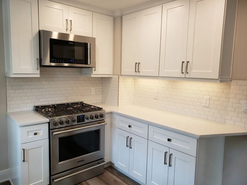 Stratford kitchen after remodel: white shaker cabinets and quartz